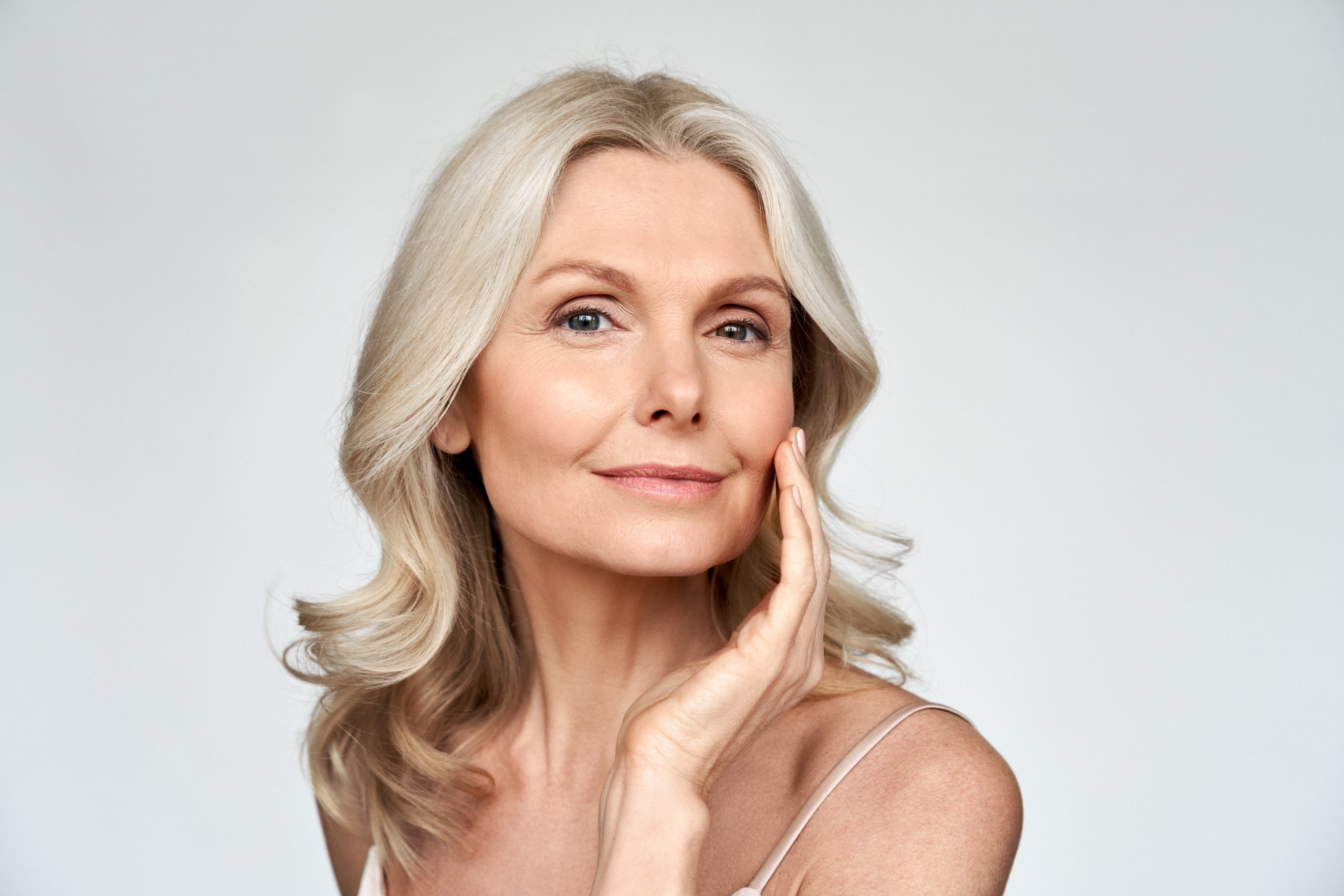 Beautiful gorgeous mid aged mature woman looking at camera isolated on white. Beautiful gorgeous mid aged mature woman looking at camera isolated on white.